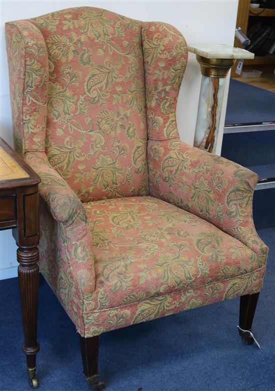 An Edwardian mahogany wing armchair